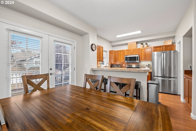 dining space with light hardwood / wood-style floors