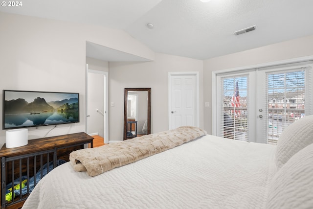 bedroom featuring lofted ceiling, access to outside, and french doors