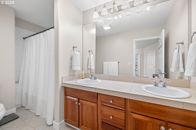 bathroom with tile patterned flooring, vanity, toilet, and a shower with curtain