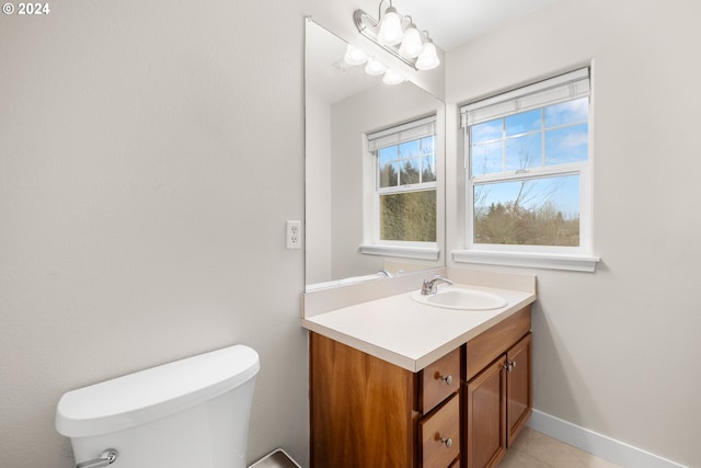 bathroom featuring tile patterned floors, vanity, and toilet