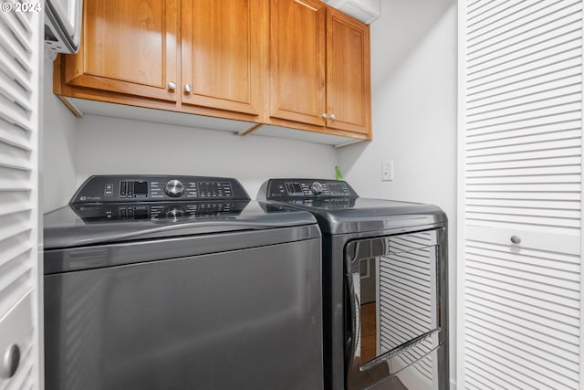 laundry area featuring cabinets and washing machine and dryer