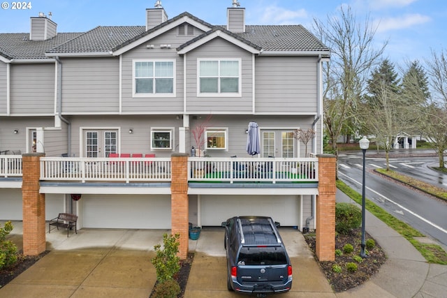 rear view of house featuring a garage