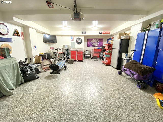 garage with a garage door opener and fridge