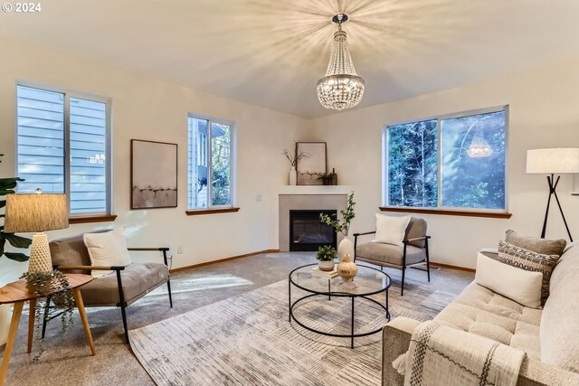 carpeted living room with an inviting chandelier