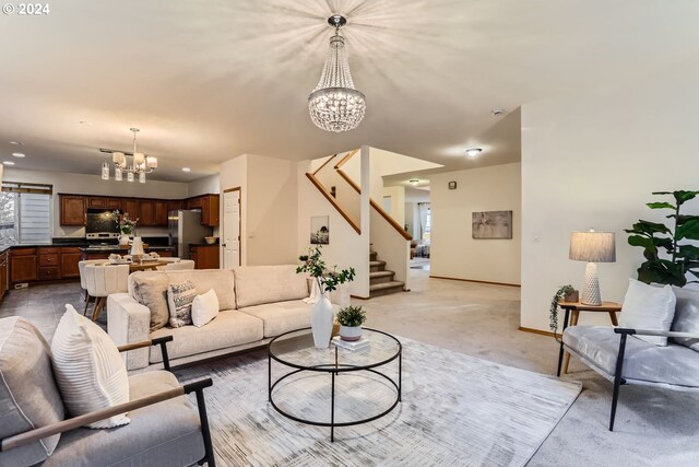 carpeted living room featuring a chandelier