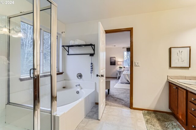 bathroom with plenty of natural light, vanity, and shower with separate bathtub