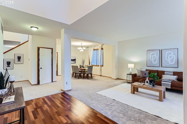 living room with hardwood / wood-style floors and an inviting chandelier