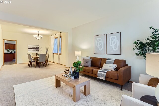 carpeted living room with a notable chandelier