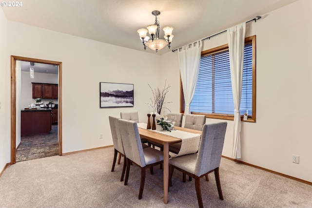 carpeted dining space with a notable chandelier