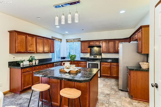 kitchen featuring pendant lighting, a center island, stainless steel appliances, and a breakfast bar area