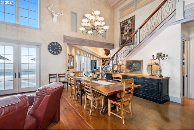 dining room featuring french doors, a towering ceiling, and plenty of natural light