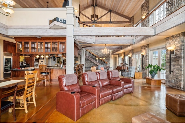 living room with wooden ceiling, beam ceiling, an inviting chandelier, and high vaulted ceiling