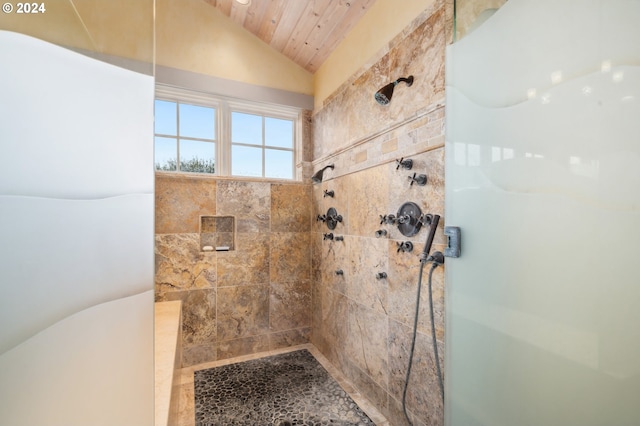 bathroom with wood ceiling, tiled shower, and vaulted ceiling