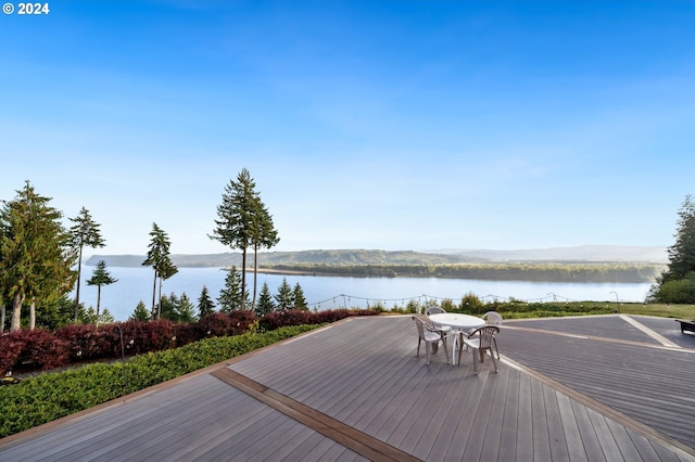 deck with a water and mountain view