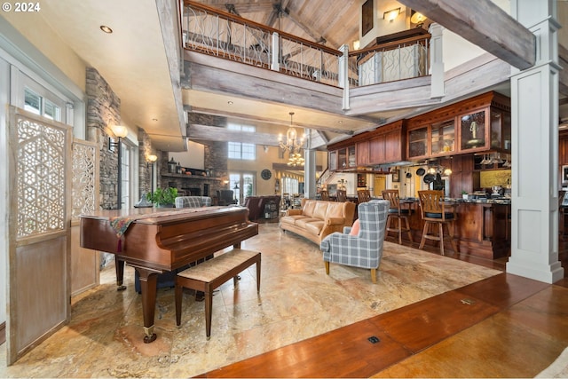 misc room featuring high vaulted ceiling, a chandelier, decorative columns, and beamed ceiling