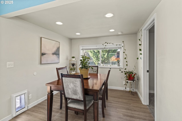 dining room with wood-type flooring