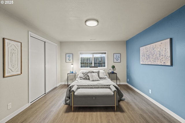 bedroom featuring hardwood / wood-style flooring and a closet