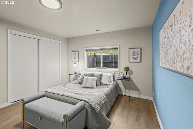 bedroom with hardwood / wood-style floors and a closet