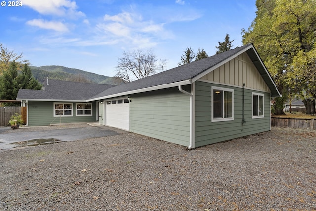 view of side of home featuring a mountain view and a garage