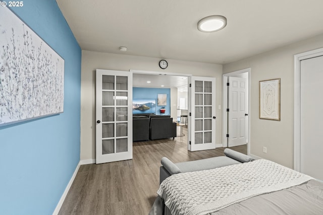 bedroom featuring hardwood / wood-style floors and french doors