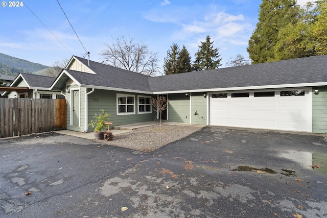 single story home featuring a garage and a mountain view