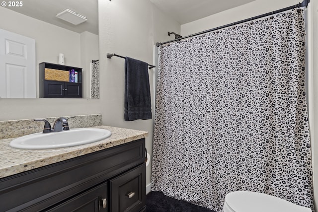 bathroom with toilet, vanity, and a shower with shower curtain