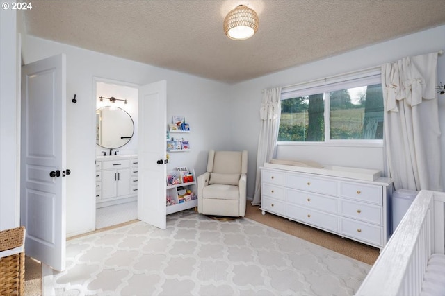 living area with a textured ceiling, light colored carpet, and sink