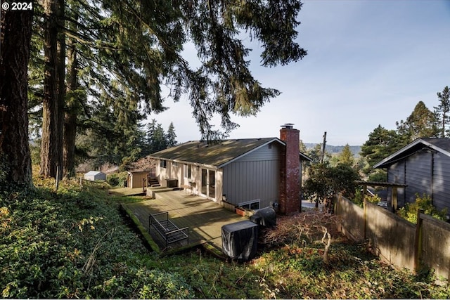 rear view of property featuring a wooden deck