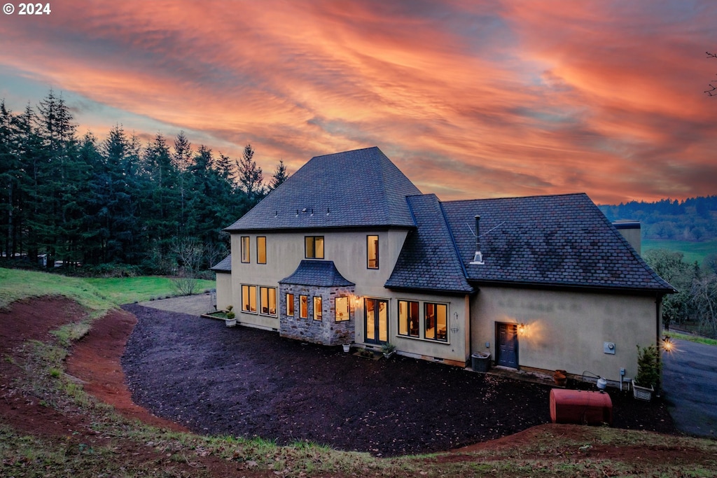 view of back house at dusk