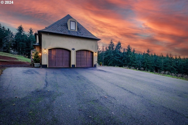 property exterior at dusk with a garage