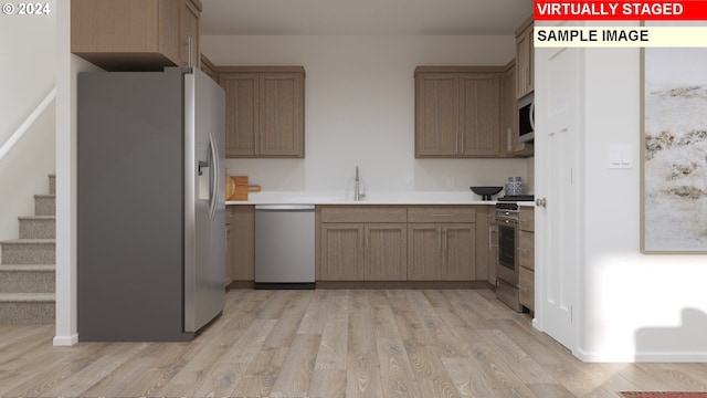 kitchen with light hardwood / wood-style floors, sink, and stainless steel appliances