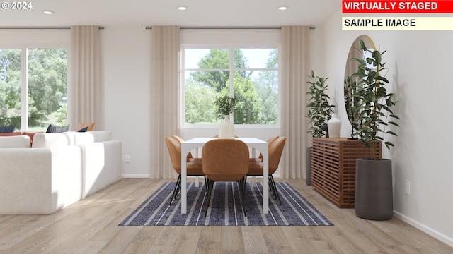 dining space with a healthy amount of sunlight and light hardwood / wood-style floors