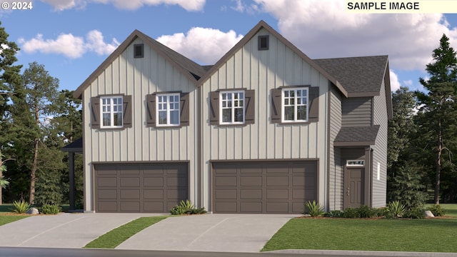 view of front of home featuring a front yard and a garage