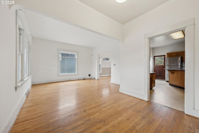 empty room featuring baseboards and light wood-style floors