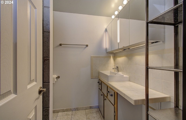 bathroom featuring backsplash, vanity, and tile patterned floors