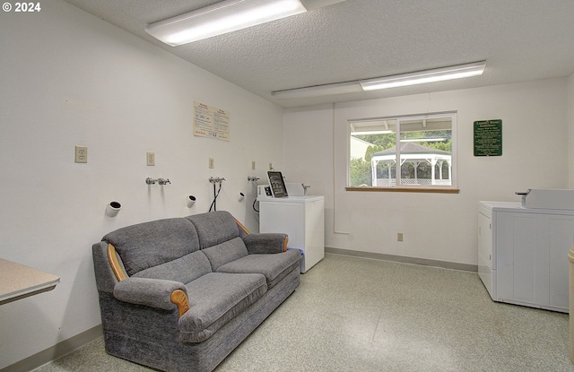 interior space featuring a textured ceiling and washer and dryer