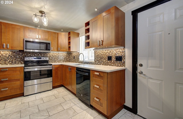 kitchen with sink, backsplash, appliances with stainless steel finishes, and light tile patterned floors