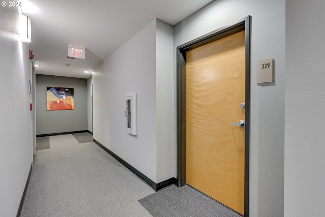 hallway featuring light colored carpet