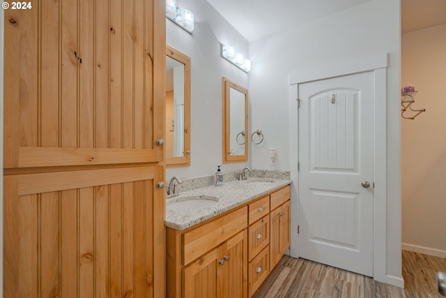 kitchen with stainless steel fridge, vaulted ceiling, backsplash, light stone countertops, and light wood-type flooring