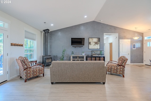 kitchen featuring light hardwood / wood-style floors, a center island, sink, vaulted ceiling, and appliances with stainless steel finishes