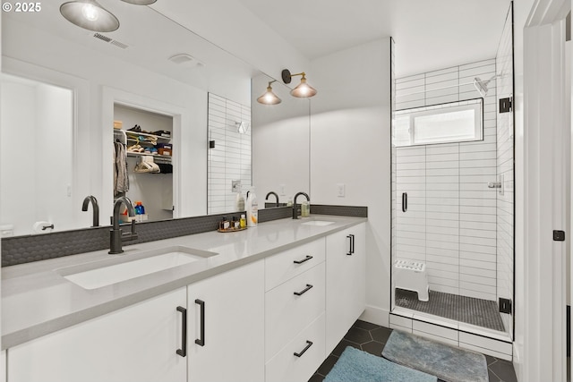 6332 NE 30th Ave, Portland, OR 97211 - full bath featuring a shower stall, double vanity, a walk in closet, and tile patterned flooring