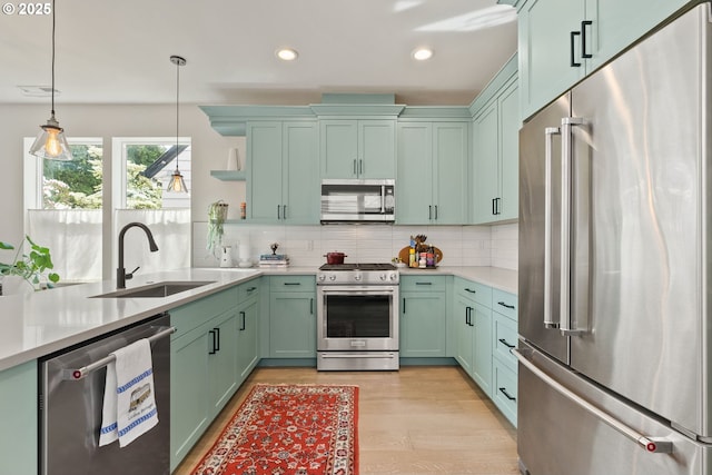 6332 NE 30th Ave, Portland, OR 97211 - kitchen with appliances with stainless steel finishes, a sink, green cabinets, open shelves, and light countertops