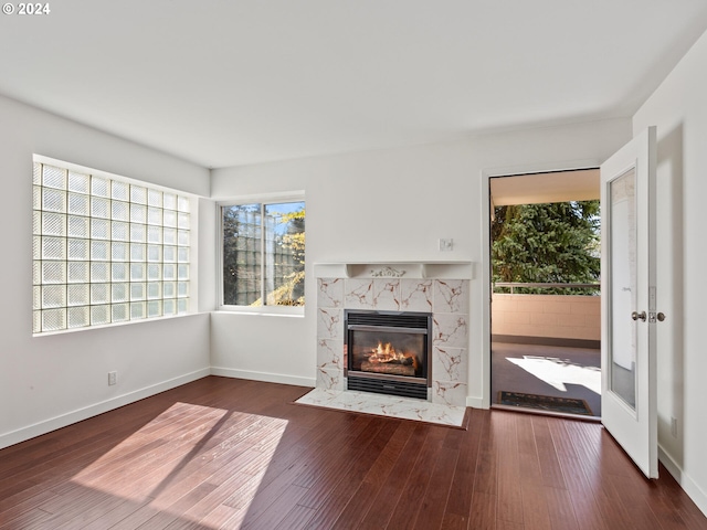 unfurnished living room featuring a fireplace and dark wood-type flooring