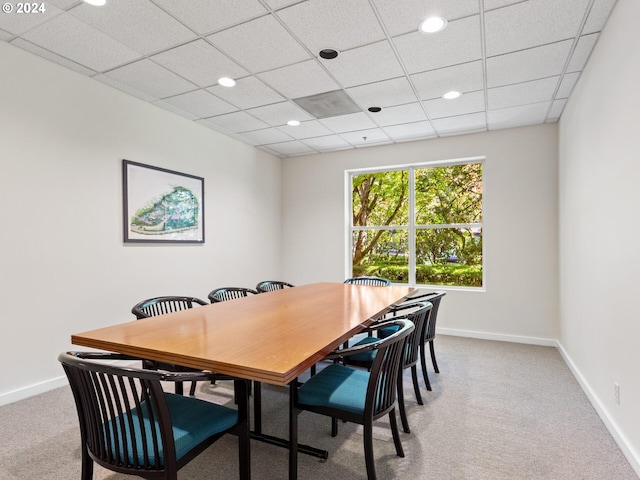 dining space with a paneled ceiling and carpet flooring