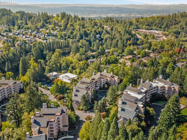 6665 W Burnside Rd Unit 413, Portland, OR 97210 - aerial view of property and surrounding area featuring a heavily wooded area