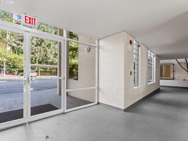6665 W Burnside Rd Unit 413, Portland, OR 97210 - doorway to outside with finished concrete flooring and concrete block wall
