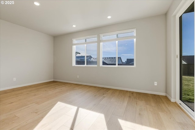 spare room featuring light hardwood / wood-style floors