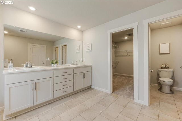 bathroom with vanity, toilet, and tile patterned floors