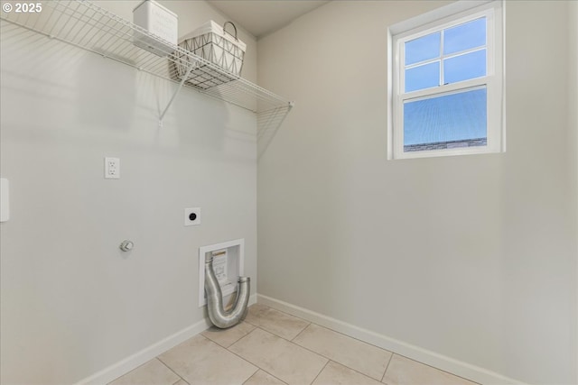 laundry area featuring hookup for an electric dryer and light tile patterned flooring