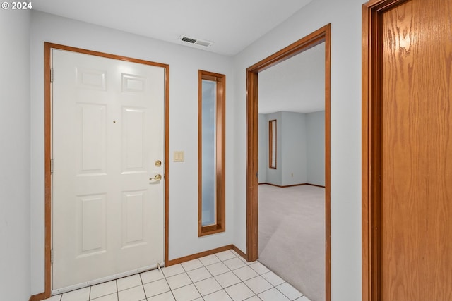 view of carpeted foyer entrance